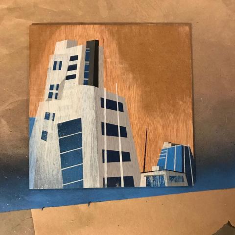 Small spray paint painting of towers in downtown Denver