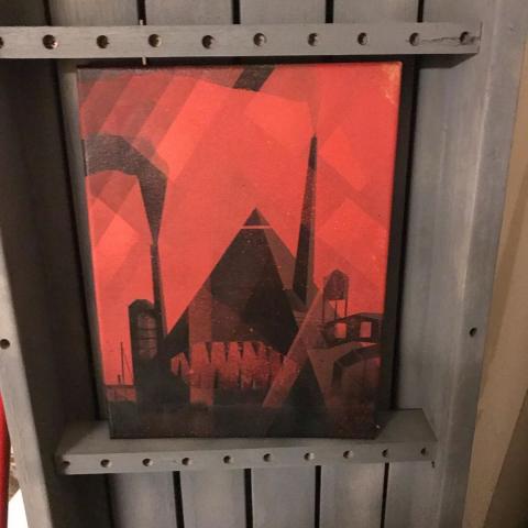Spray paint painting of a triangular machine with teeth